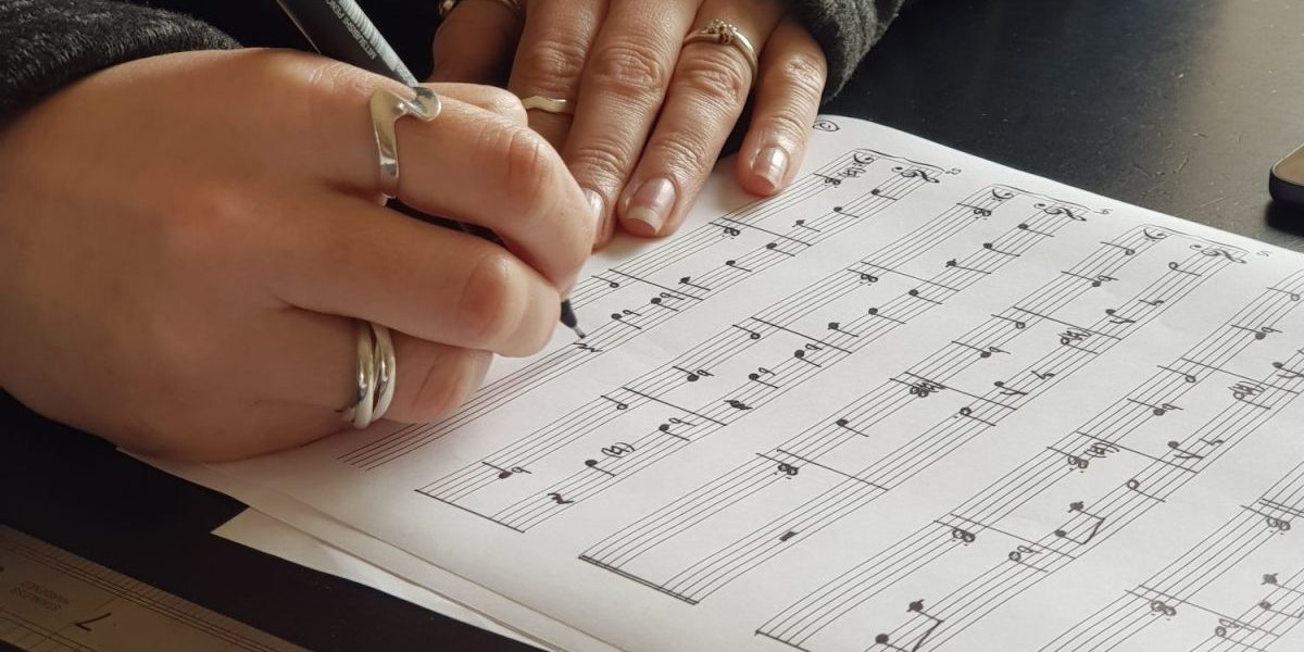 music notes being written on a sheet